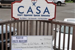 An oversized check for $21,796 is made out to CASA of Del Norte.