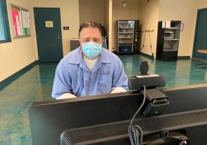 Mule Creek State Prison incarcerated man Michael Kendall looks at a computer screen.
