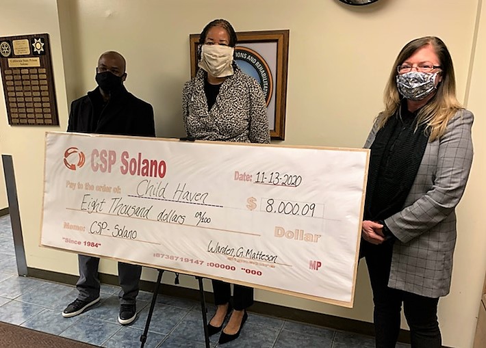Solano prison staff present an oversized check to Child Haven.
