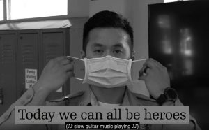Office puts on mask. Text beneath says 'We can all be heroes.'
