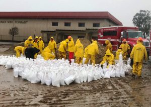 Gabilan Conservation Camp crews fight Monterey County floods by filling sandbags.