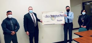 Three people from California Institution for Men present a check to Chino Neighborhood House.