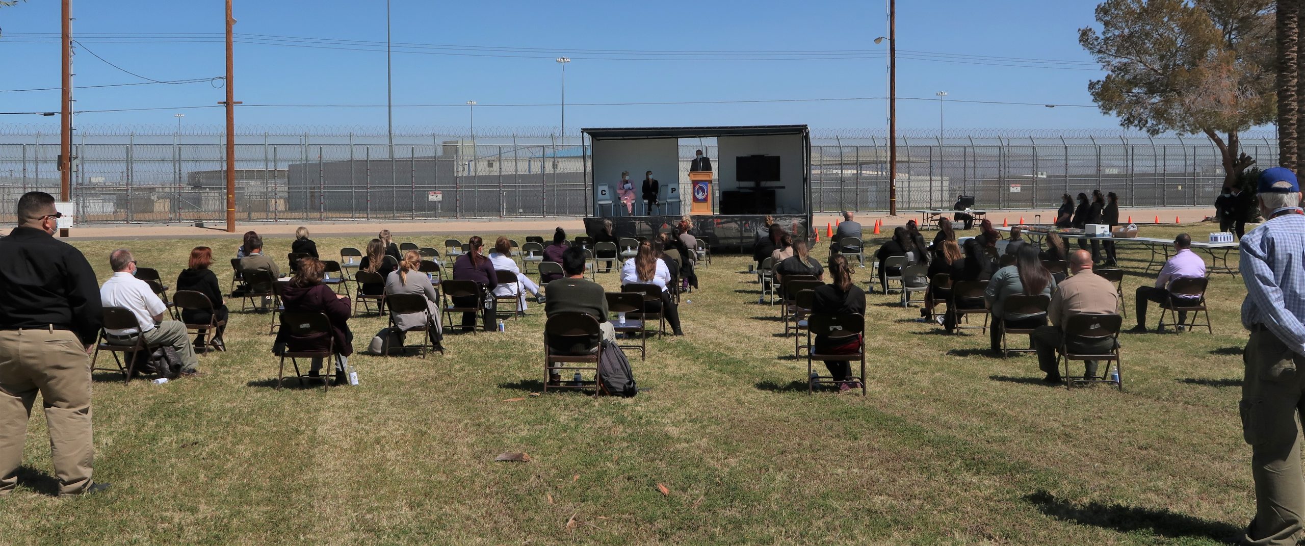 People sit in chairs at Chuckawalla prison for National Women's History Month.