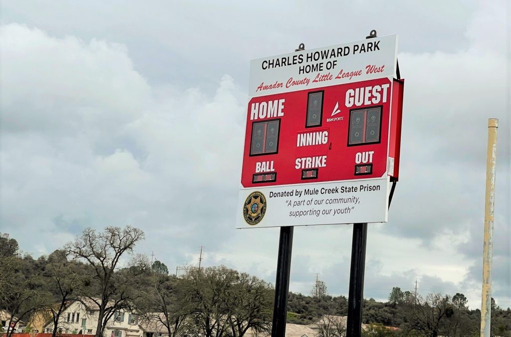 Baseball score board has sign saying "donated by Mule Creek State Prison."