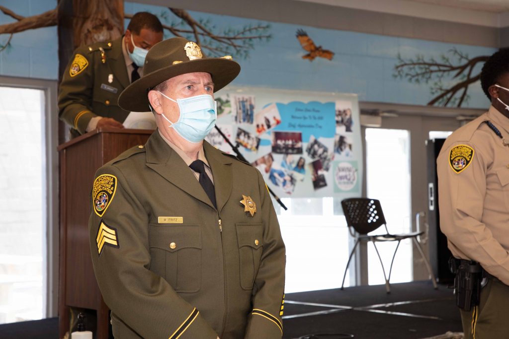 Correctional Sergeant at attention wearing a mask