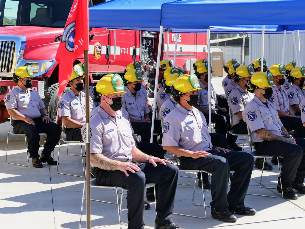 Firefighter training cadets sit in chairs.