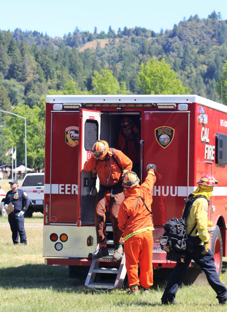 Incarcerated firefighters file out of a fire vehicle.
