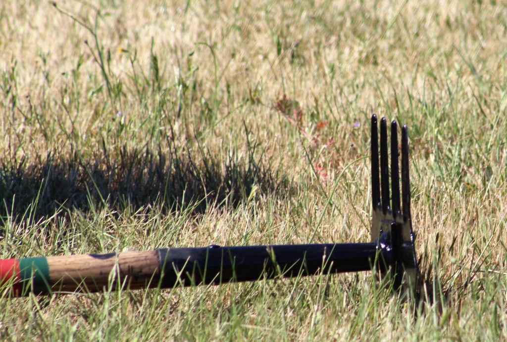 A firefighting tool sits in the field.