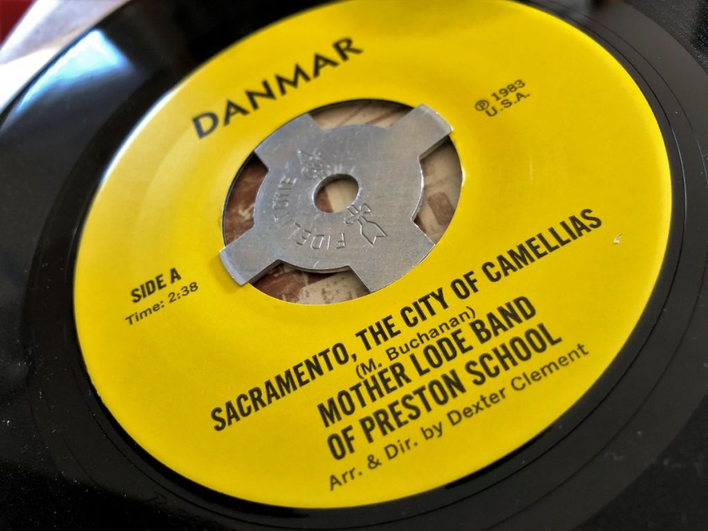 A record with the words "Danmar, 1983, Side A, Sacramento, the City of Camellias."