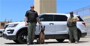 Highway wreck found two correctional officers, shown here with a K-9 at a prison, helping.