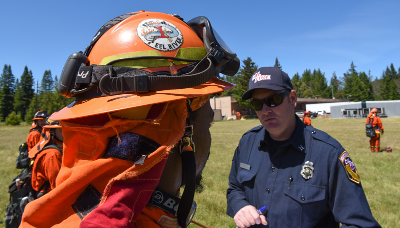 CAL FIRE inspects an incarcerated firefighter.
