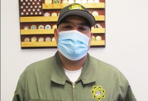 A correctional officer with B Diaz on his uniform.