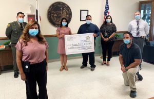 SATF staff present a check to refuge founders.