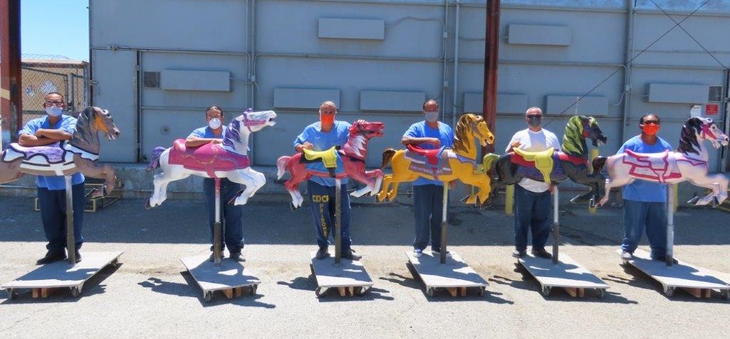 Avenal prison inmates and colorful carousel horses.