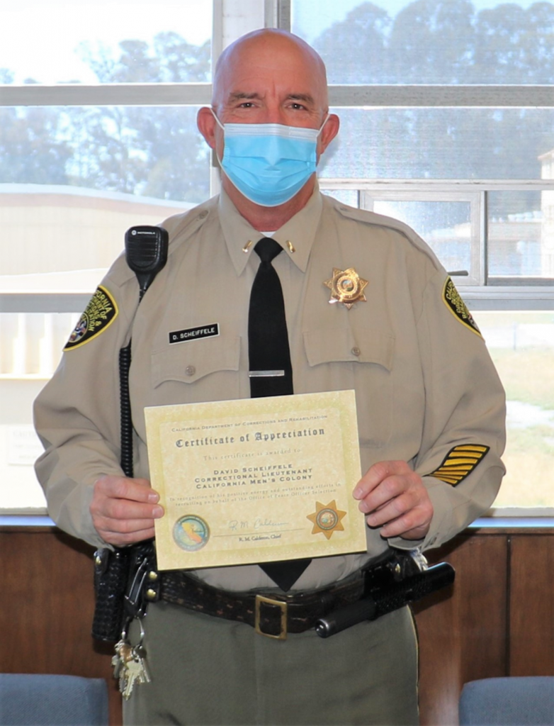 Correctional lieutenant holds certificate.