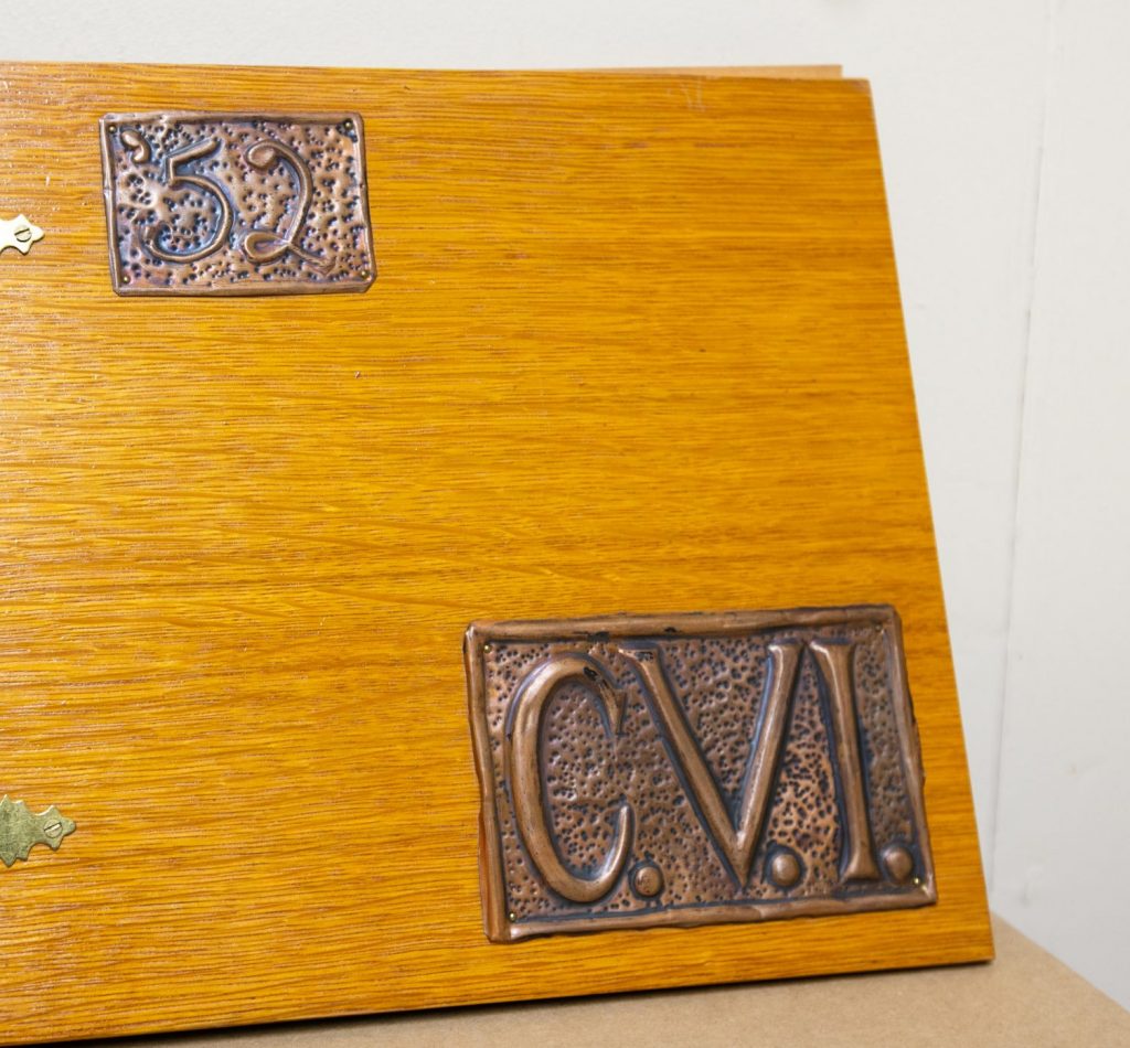 A wooden book with 52 and CVI initials on the cover.