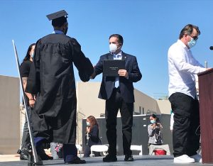 A man receives a degree during a ceremony.