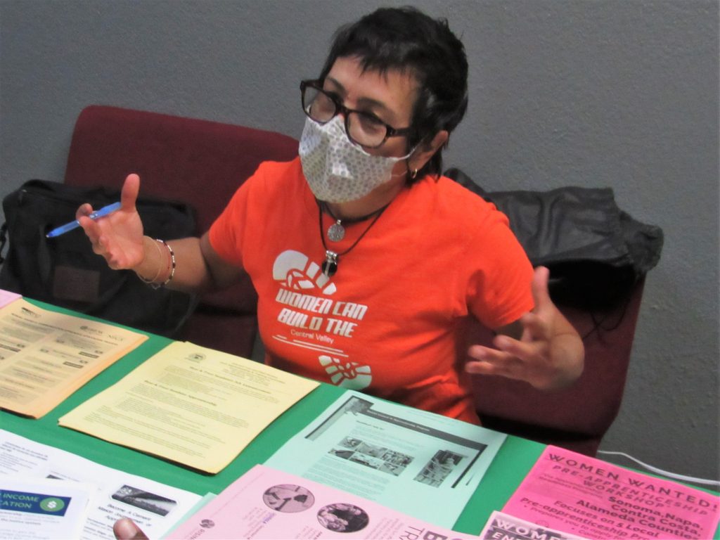 Woman at DAPO Reentry Resource Center with job information pamphlets.