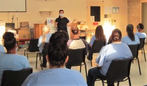 Prison staff member speaks to incarcerated population in prison.