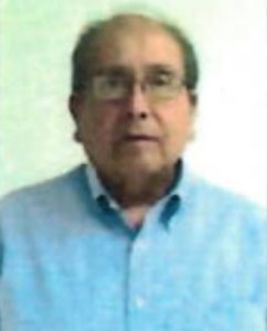 Carlos Guzman wearing glasses and a blue shirt.