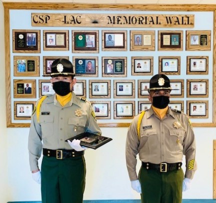 Retired warden Otis Thurman plaque held by two prison Honor Guard members.