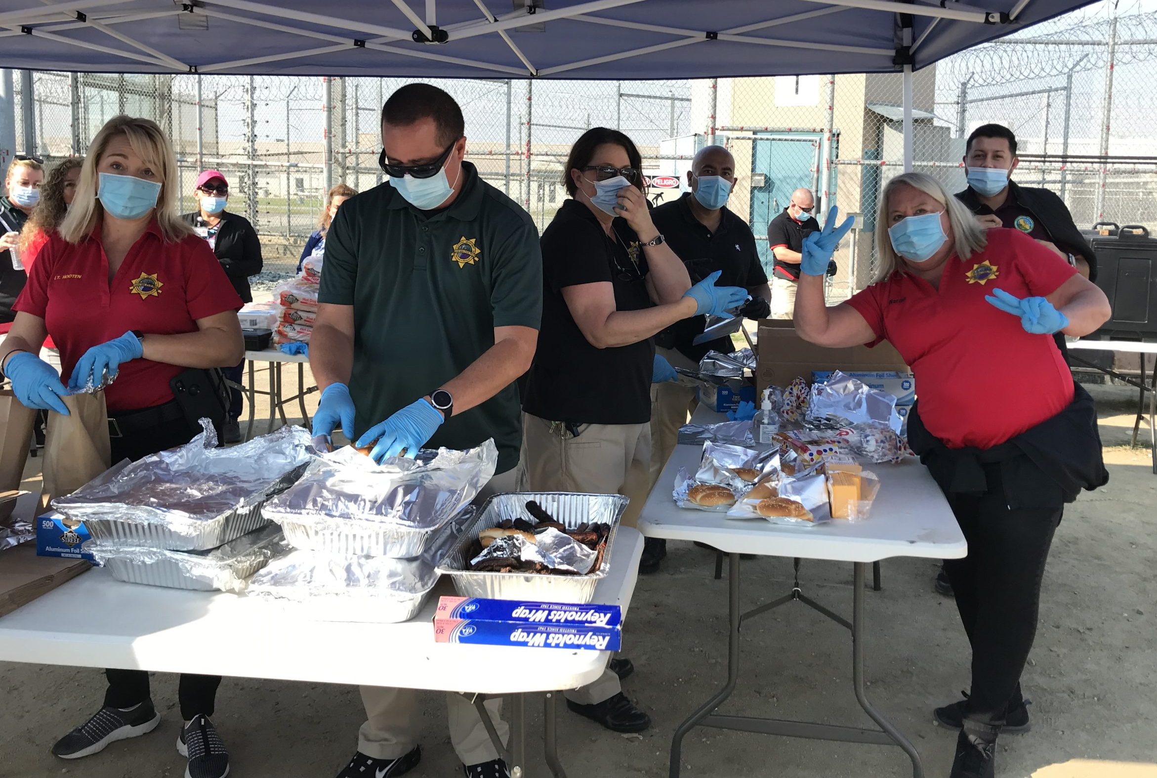 North Kern prison staff around a table with barbecue food.
