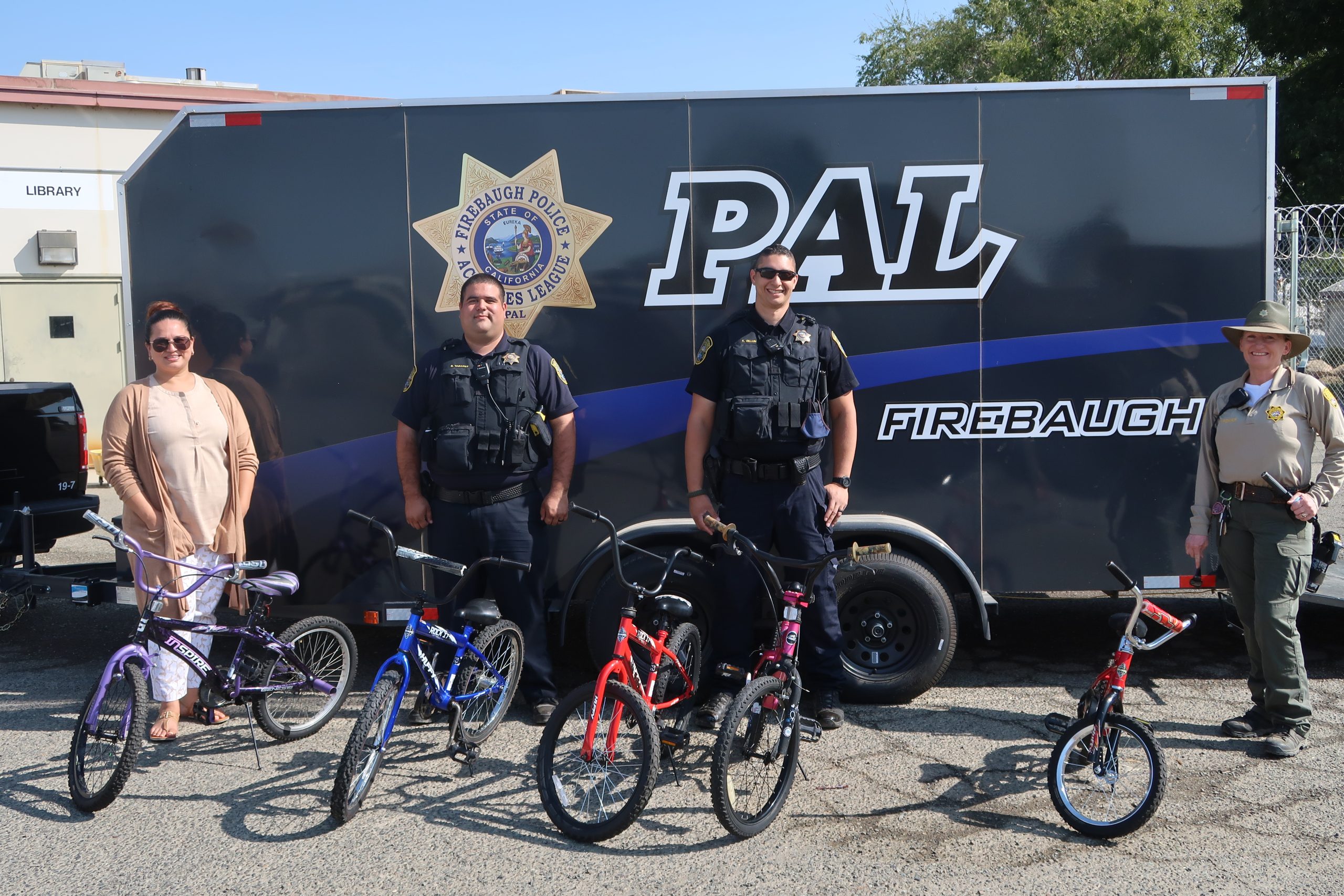 Two police officers and Pleasant Valley prison staff from bike program.