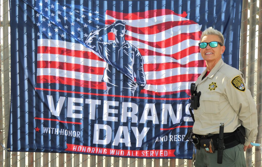 SATF veterans day banner and correctional officer.