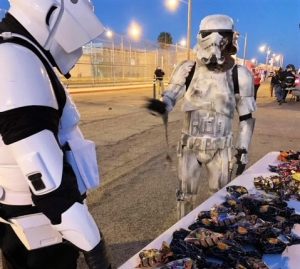 CIM trick-or-treating event with two Star Wars character and prison in background.