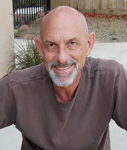 Retired counselor Charles Eisenhauer smiling at camera.