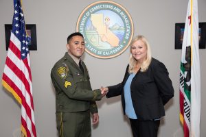 Sergeant Villareal and Secretary Allison shake hands.
