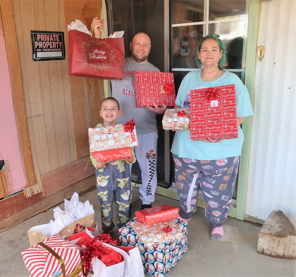 Family holds gift bags.