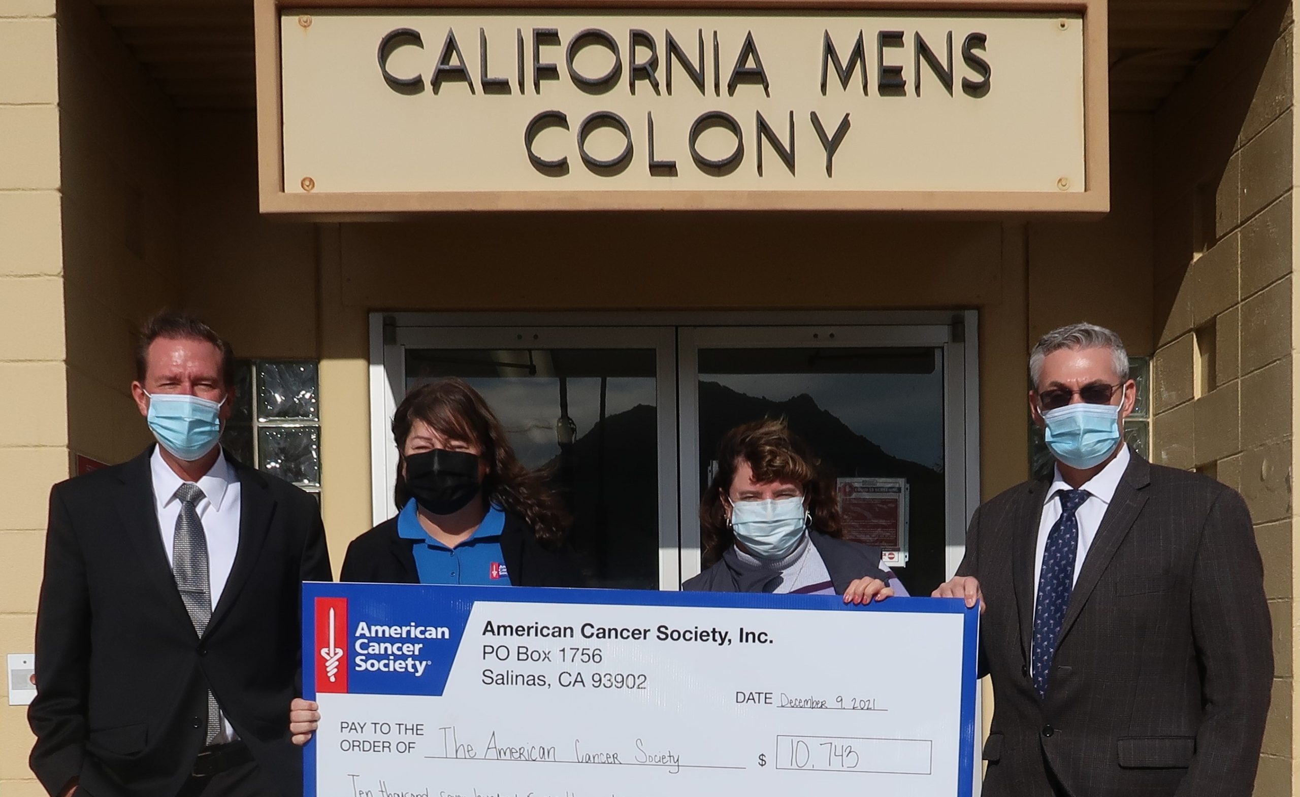 California Men's Colony staff present a check to American Cancer Society.