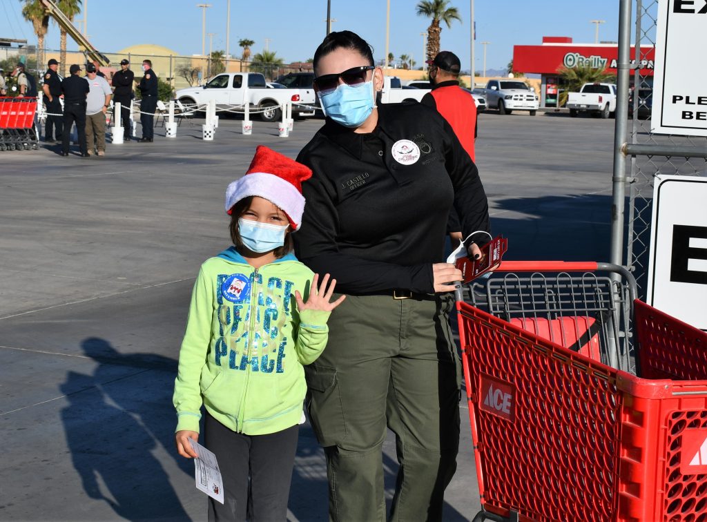 CDCR officer and a child with a shopping cart.