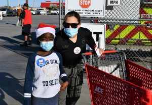 CDCR sergeant and child with shopping cart.