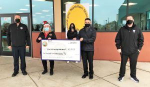 North Kern prison warden presents donation to high schools.
