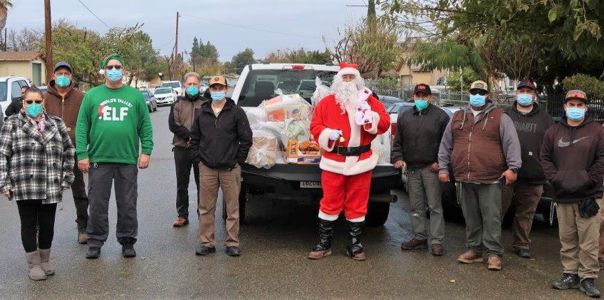 CDCR volunteers and a Santa with a truckload of gifts.