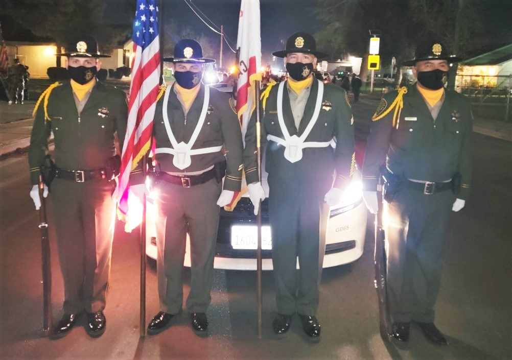 CDCR honor guard members hold flags.
