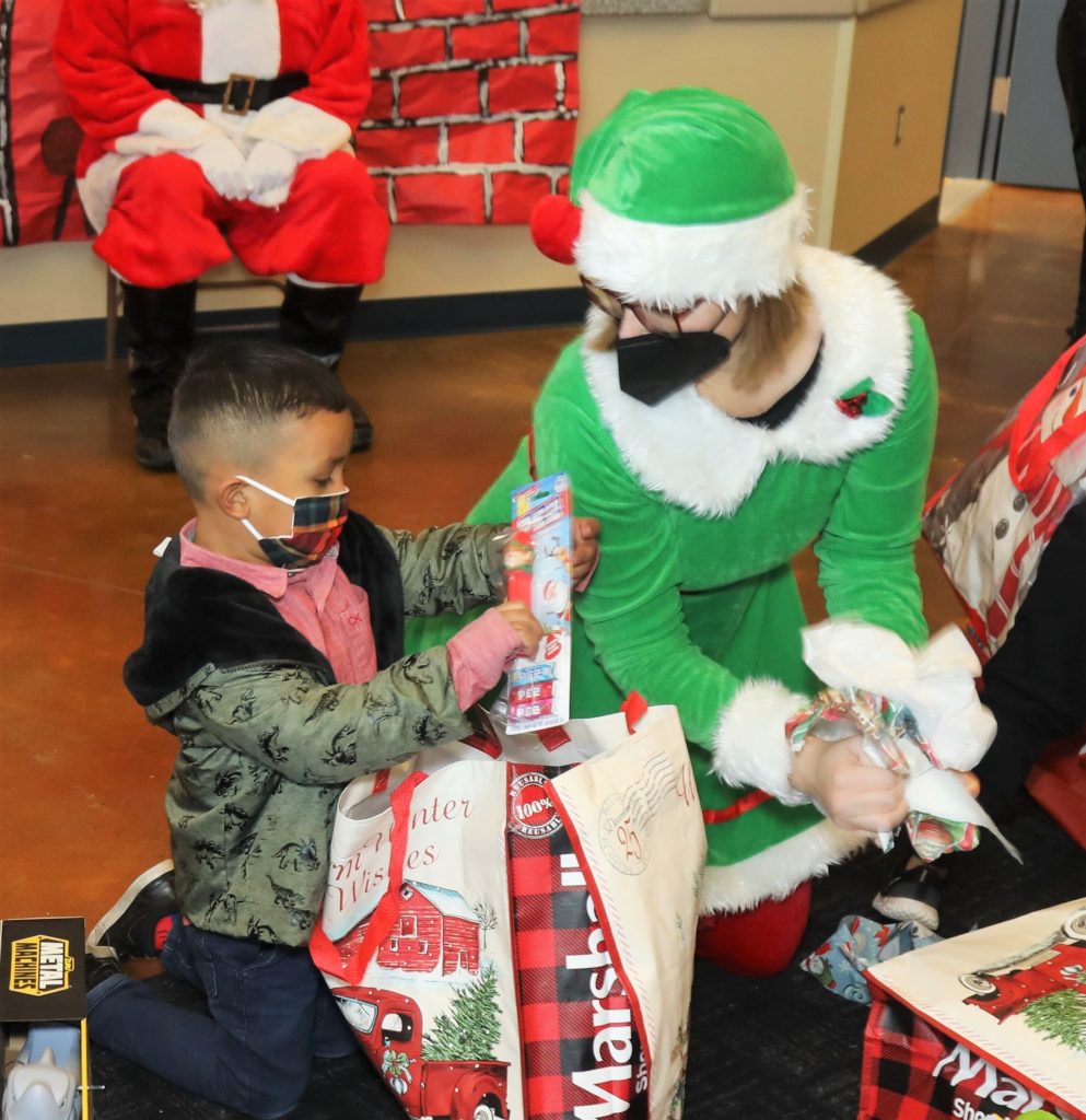 CDCR volunteer elf and a child.