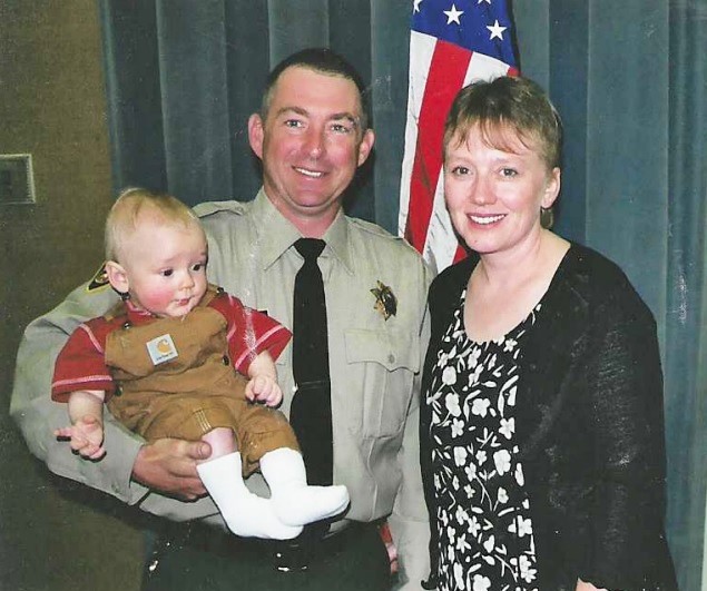 Fire Captain Mallery as an officer in 2002 with his wife and first child.
