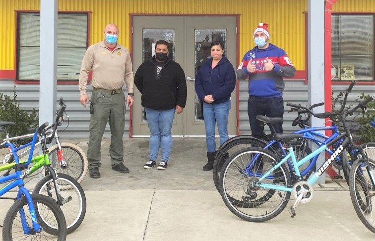 Huron staff greets CDCR Sergeant Depond and refurbished bicycles.