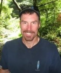 Obituary photo of Todd Donoho in nature setting.