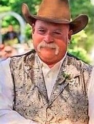 Retired officer George Marantos wears cowboy hat and vest.