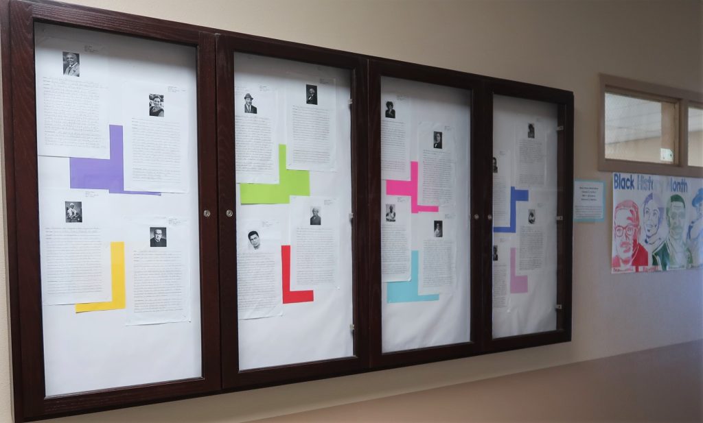 Black History Month essays displayed on wall at Avenal prison.
