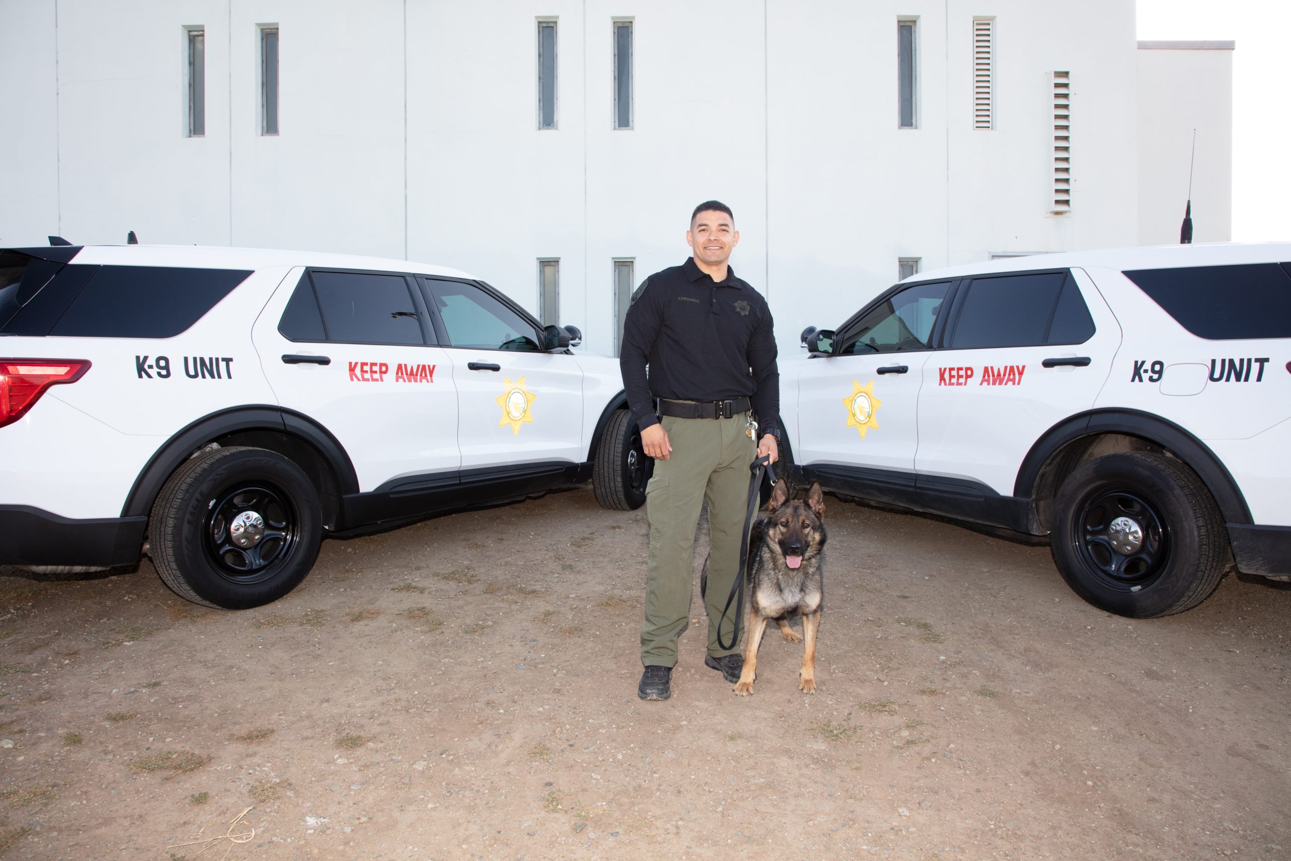 Correctional officer Fernandez and a dog.