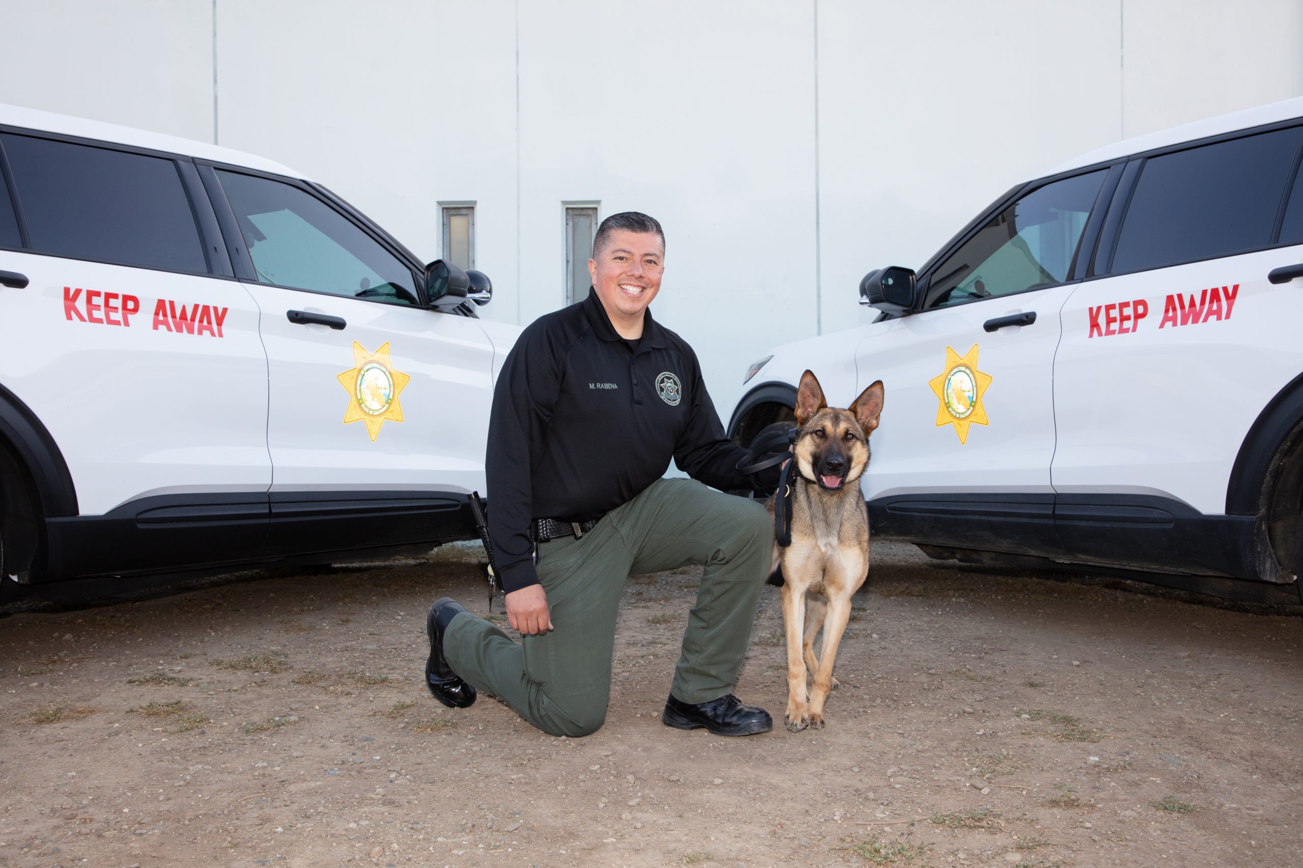 Correctional officer Rabena, two vehicles and a CDCR K-9.