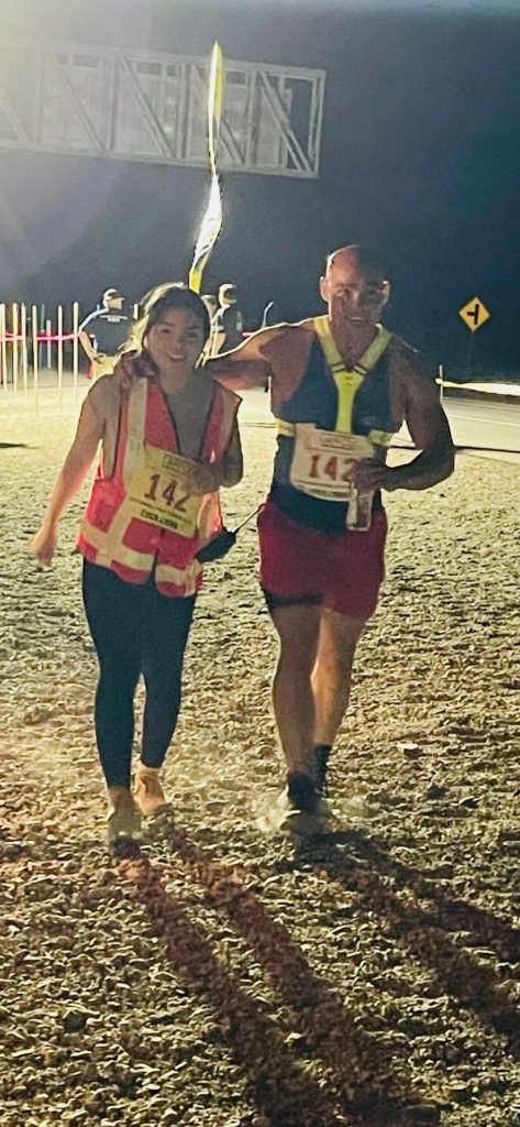 Man and woman runner with reflectors on at night
