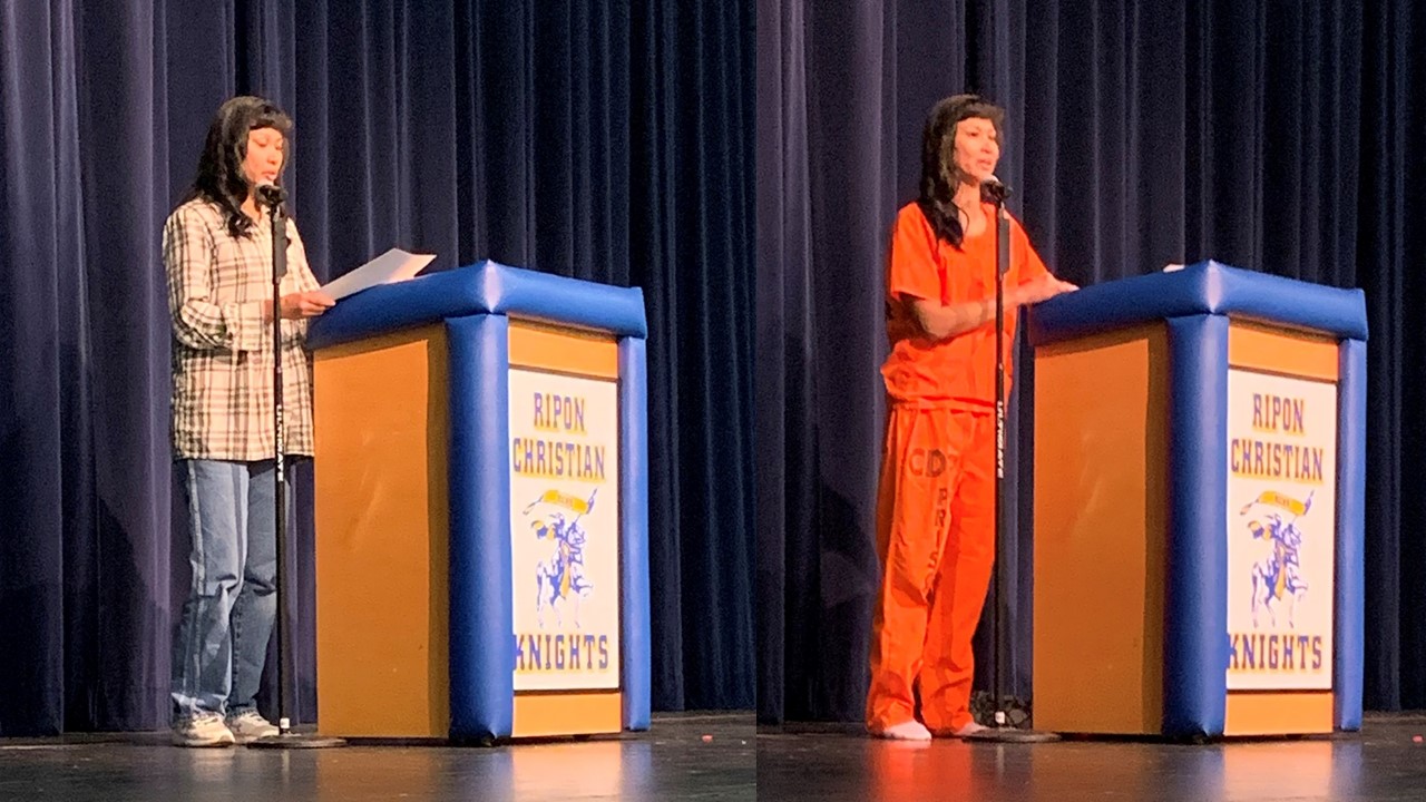 Incarcerated firefighter speaks at a lectern at Every 15 Minutes program. Photos shows her in regular clothing, at left, and in a CDCR prisoner orange outfit.