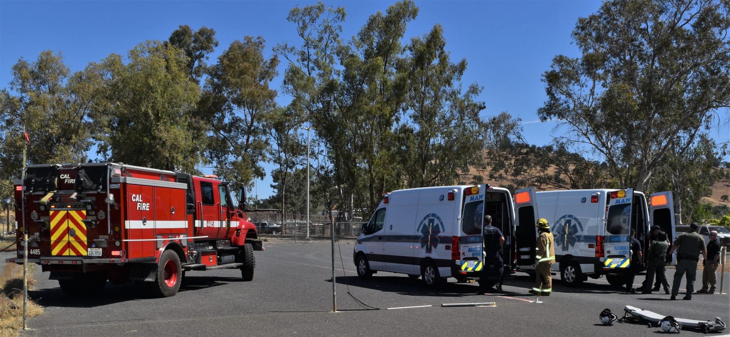 Ambulances and fire truck at a staging area for a disaster training drill.
