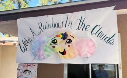 Brightly colored banner with the words "We're a rainbow in the clouds."